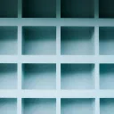 A grid of empty pale-blue shelf compartments
