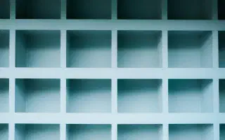 A grid of empty pale-blue shelf compartments